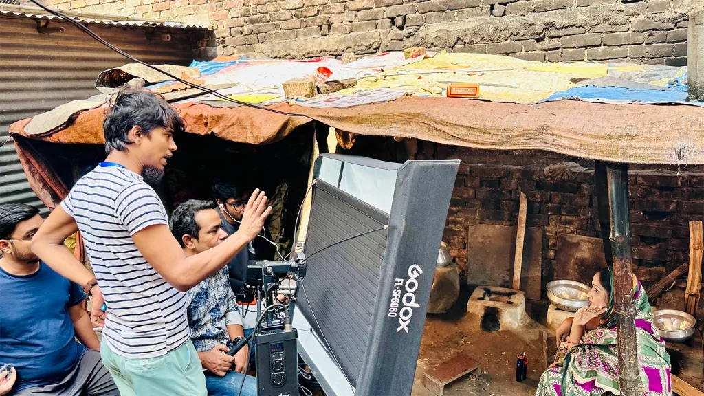 Faisal Khan Shuvo directing Apon Hoyeo Por BTS in a courtyard set with crew and actor