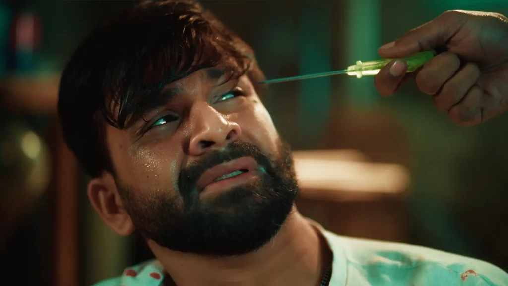 A distressed captive reacts as a screwdriver is held near his eye in the Bangla Full Natok Sei Ami Nei Ami.